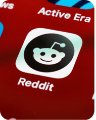 The Reddit app icon on a phone screen